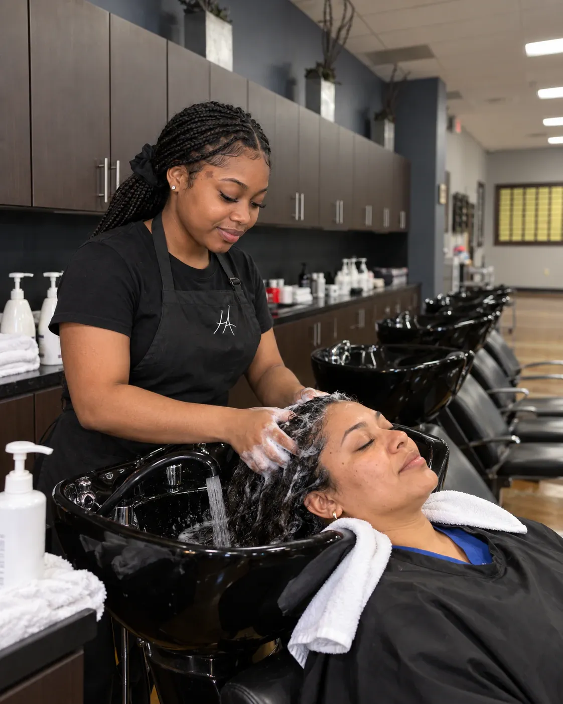 Cosmetology student shampooing a client at the Hays campus